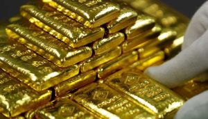 Gold falls but still set for weekly gain